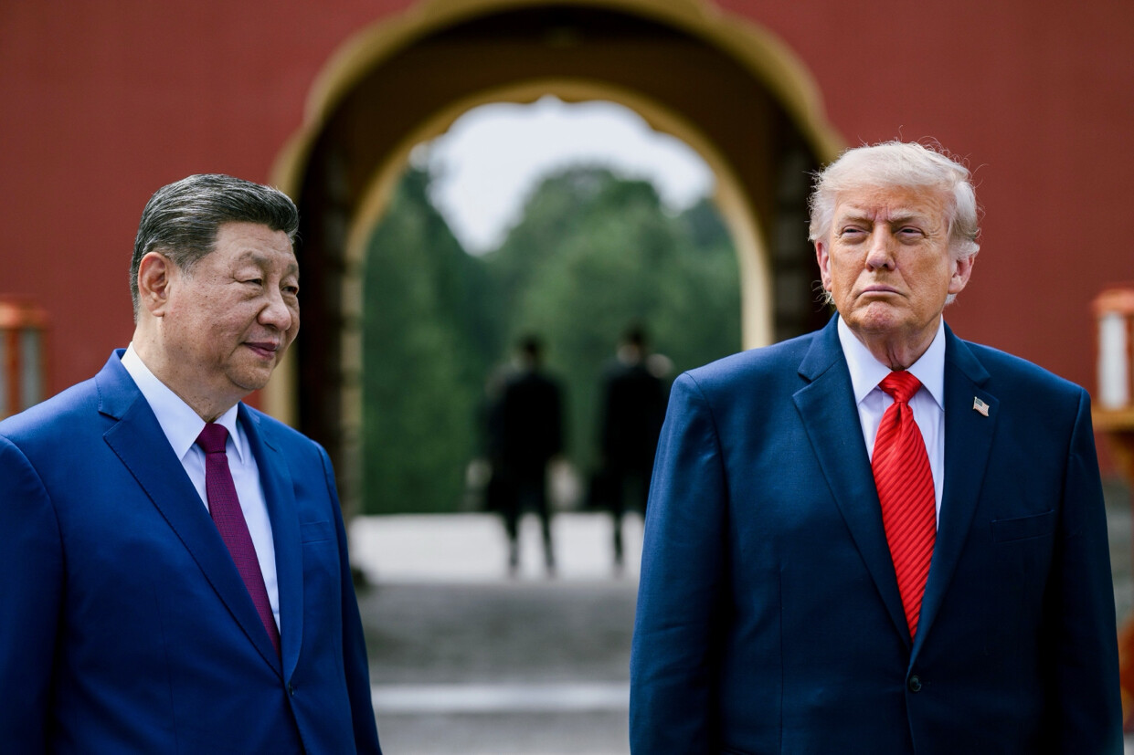 Two unidentified men stood at an East Asian-style architectural structure on 07/14/2026. The wordless post by Donald J.