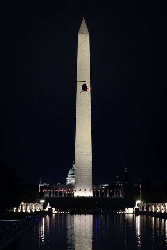 The Washington Monument and the U.S. Capitol are depicted at night in Washington, D.C.