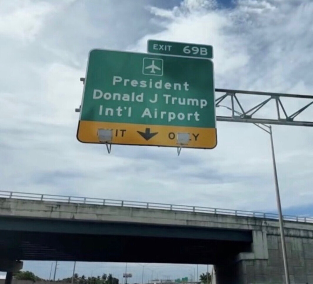 A highway sign displays directions to President Donald J. Trump International Airport at Exit 69B on Interstate 95 in South Florida on 07/11/2026.